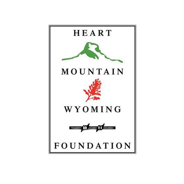 A green mountain, red plant, and black barbed wire between words 
