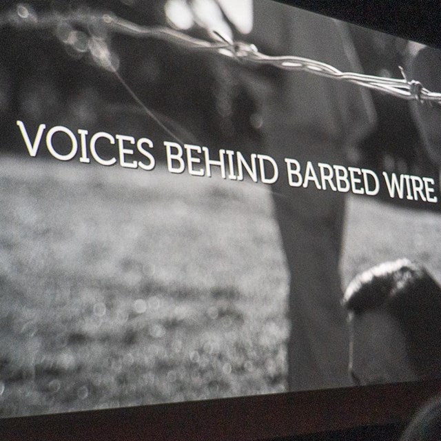 A black and white shot of a movie screen with the title 