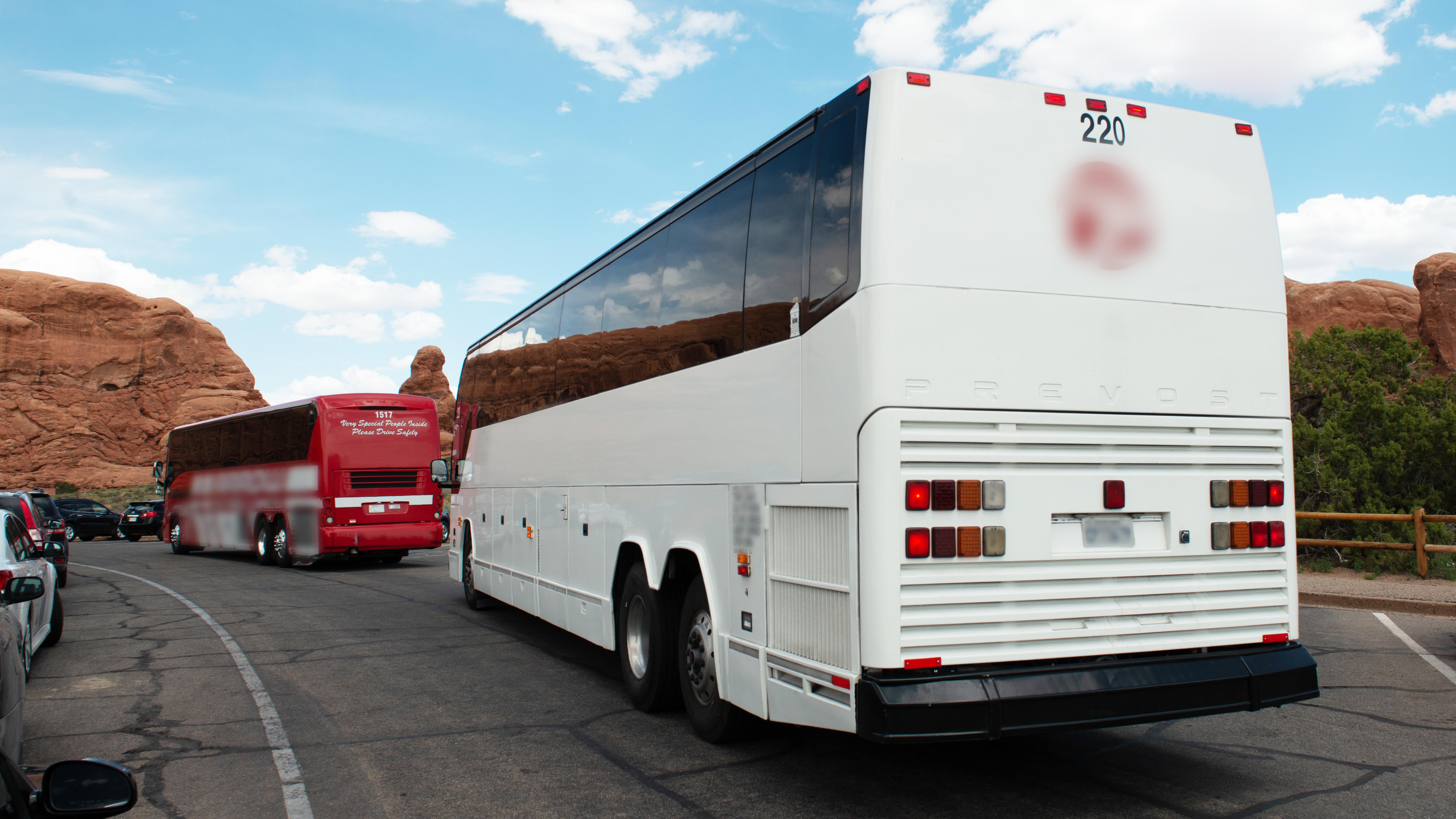 A large white bus in a parking area
