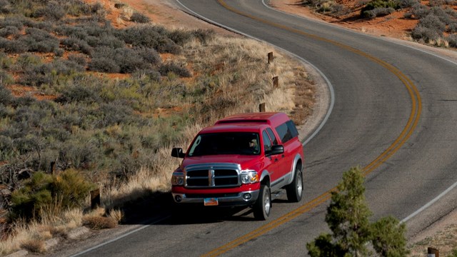 a red truck on a paved road