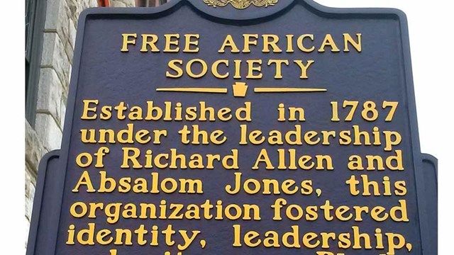 Blue historical marker with yellow text titled "Free African Society."