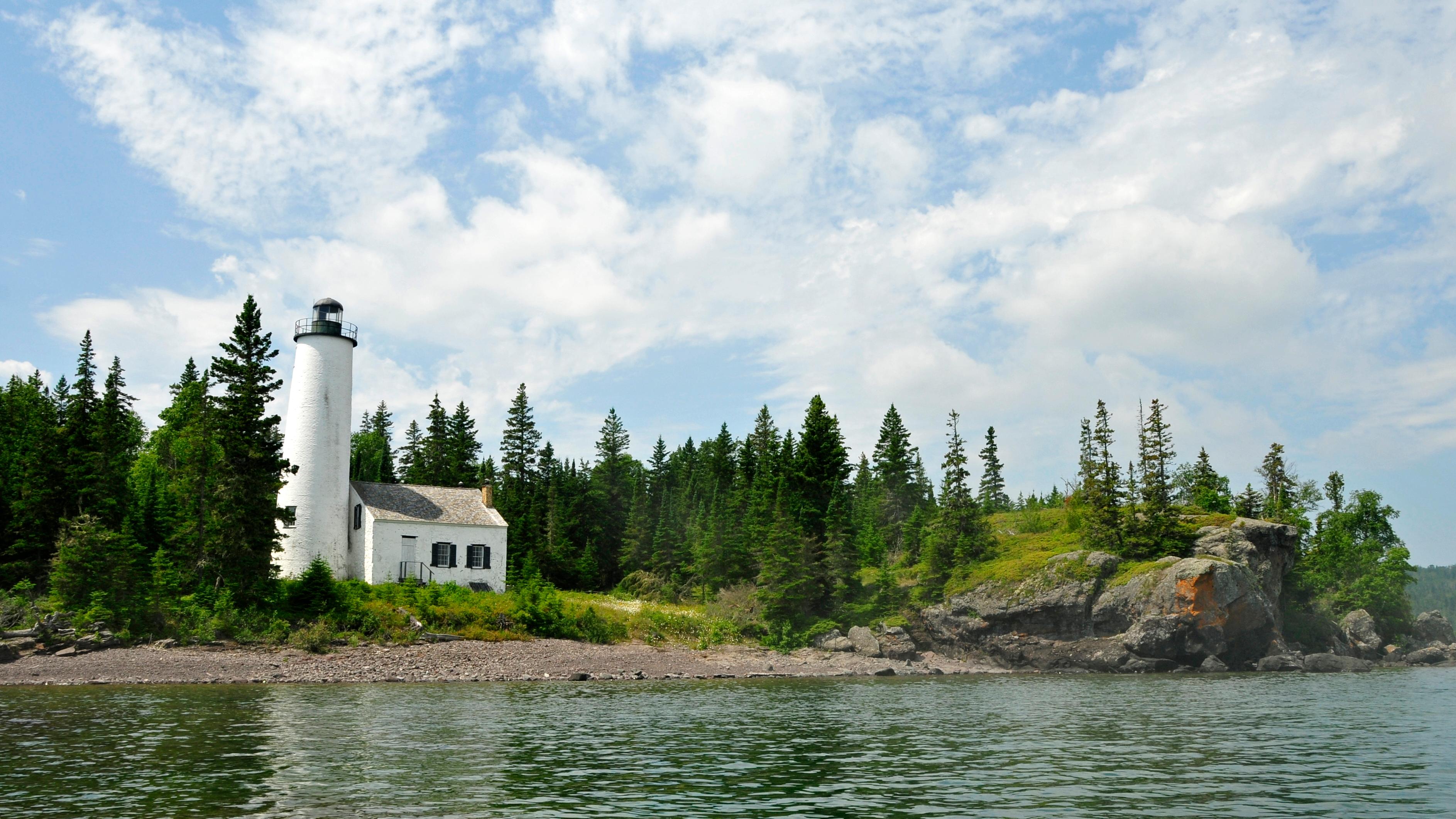 view of lighthouse from Middle Islands Passage on a blue sky day
