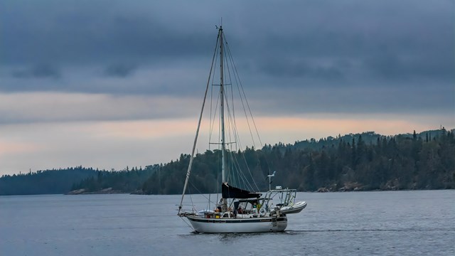 A white sailboat sailing in Lake Superior.