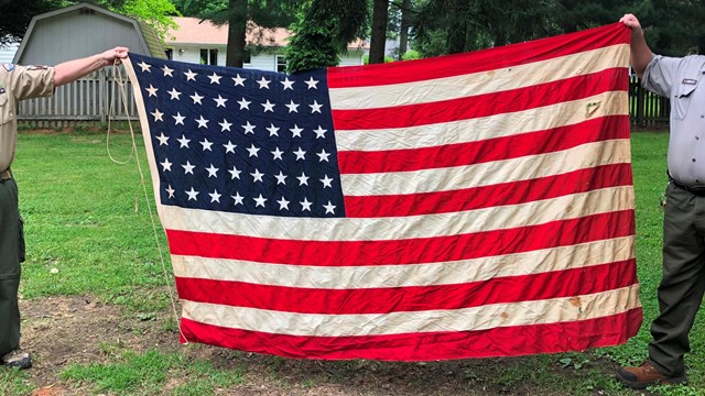 Scouts folding an American flag