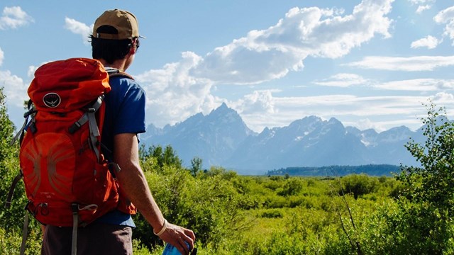 man looks at mountains in distance