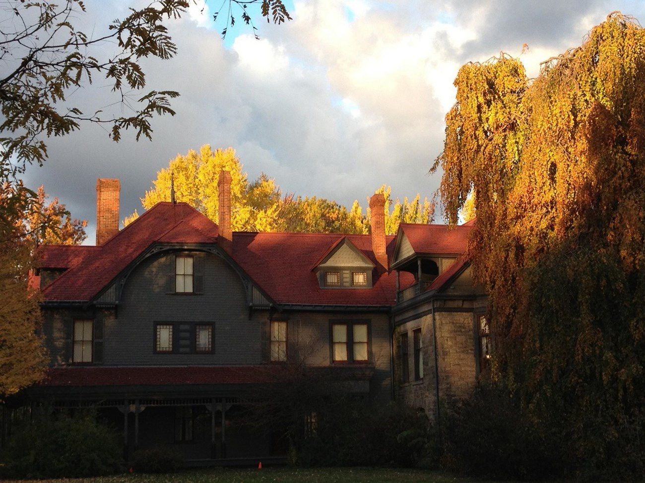 East side of Garfield home with fall trees and cloudy fall sky.