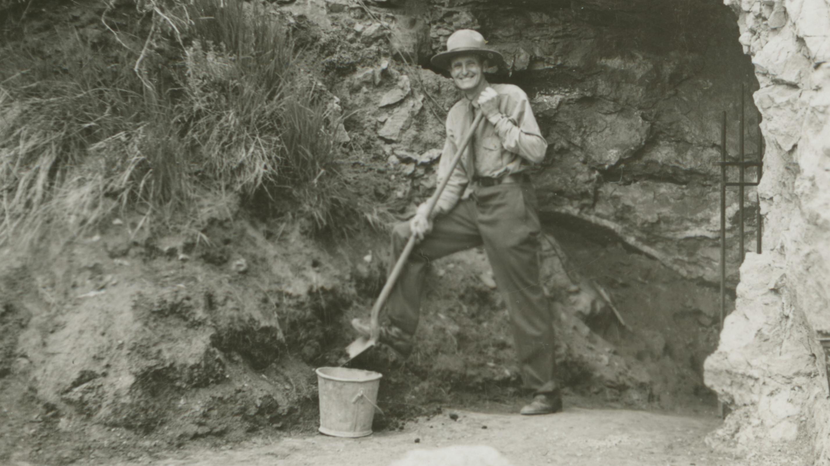 A Park Ranger standing in front of the Historic entrance to the cave.