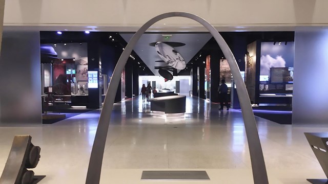 A model of the arch, with a dark museum in the background