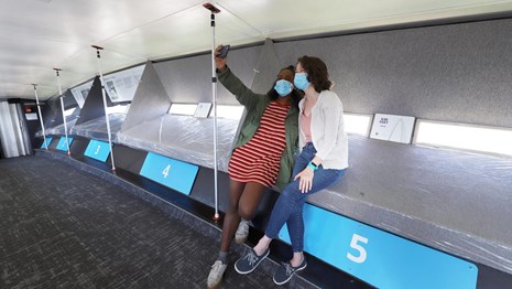Two people take a selfie from the observation deck at the top of the Gateway Arch.