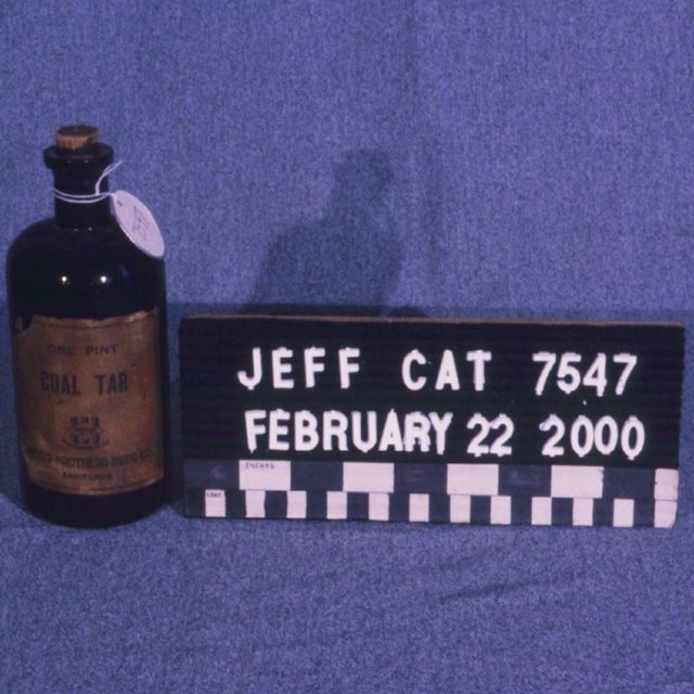 An old-fashioned glass jar labeled 
