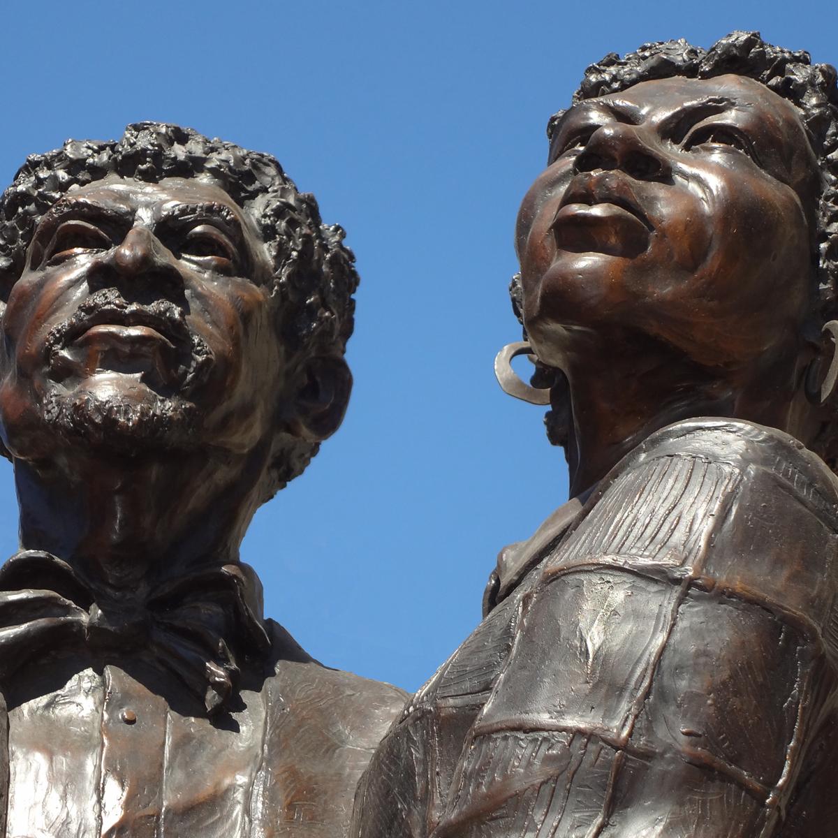 Bronze statue of a man and woman (Dred and Harriet Scott) looking to the sky