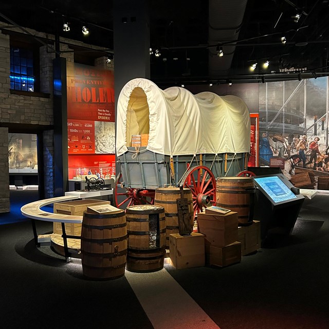 A wagon covered with white canvas