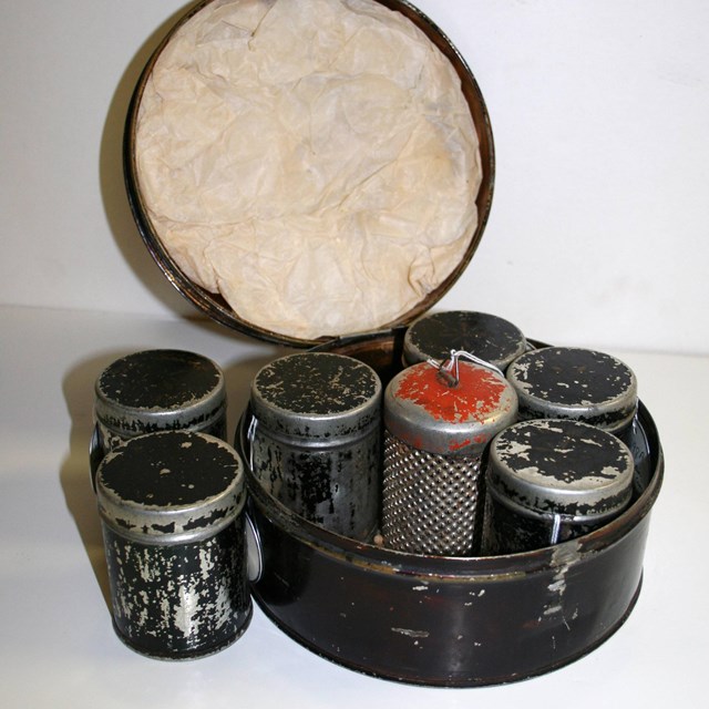 Several small cans in a larger carrying container