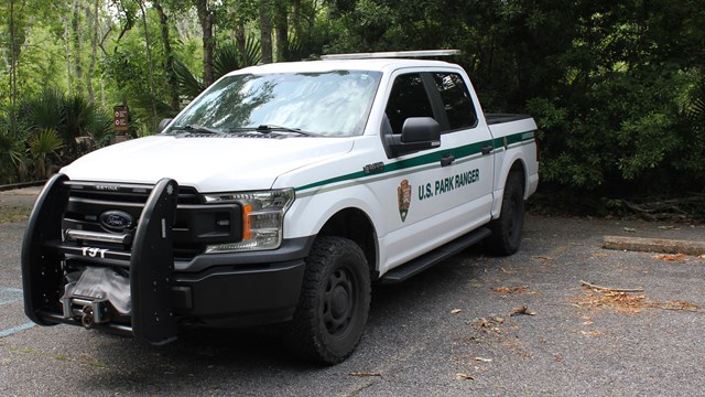 An NPS law enforcement patrol truck in a parking space.