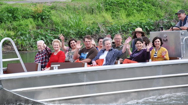 People on a Boat tour many people and with 2 rangers on Bayou Lafourche