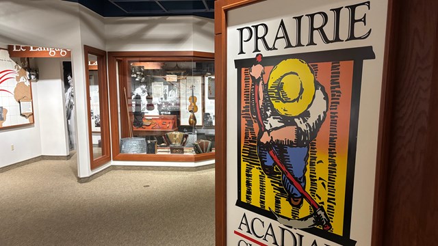museum entrance sign with music exhibit cases in the distance