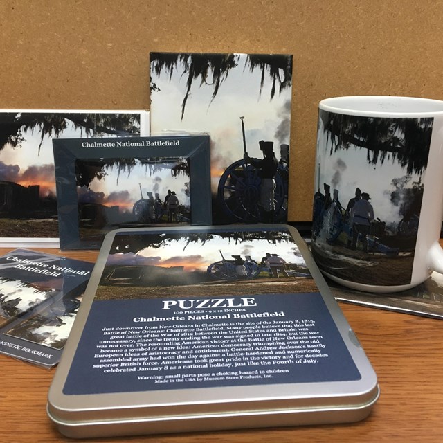 Table top with a puzzle, mug, and pictures on top.