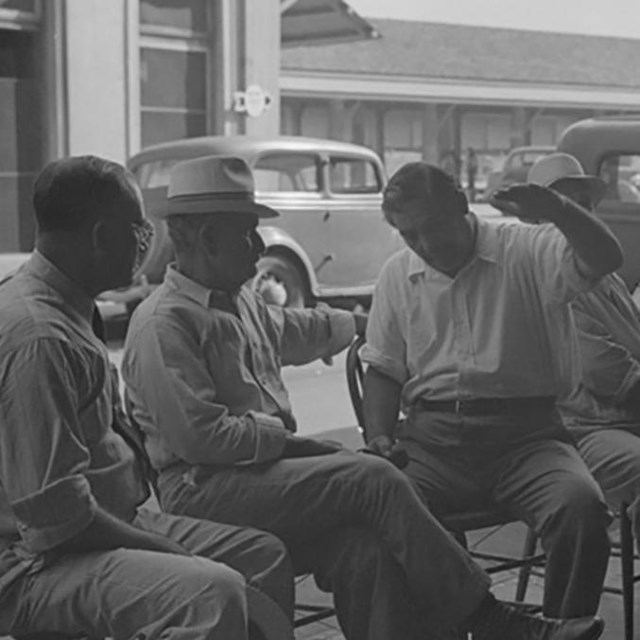 italian men sit on decatur street corner historic photo