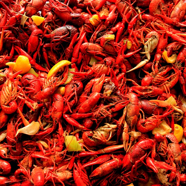 a pile of boiled crawfish with citrus and seasonings