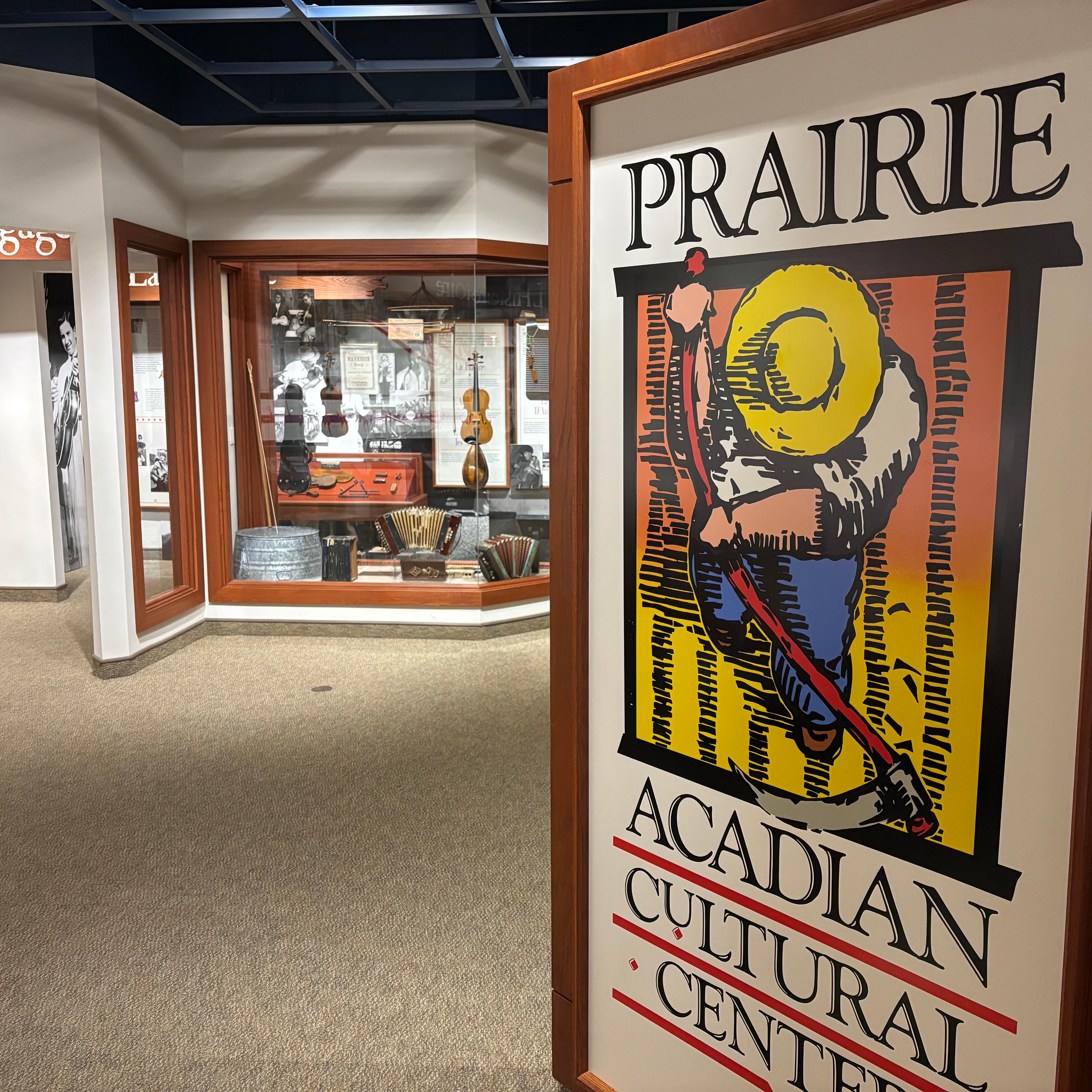 museum entrance sign with music exhibit cases in the distance