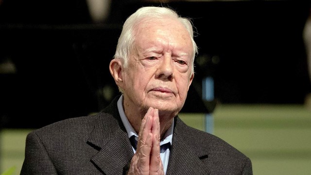 Photo of Jimmy Carter with hands clasped in prayer