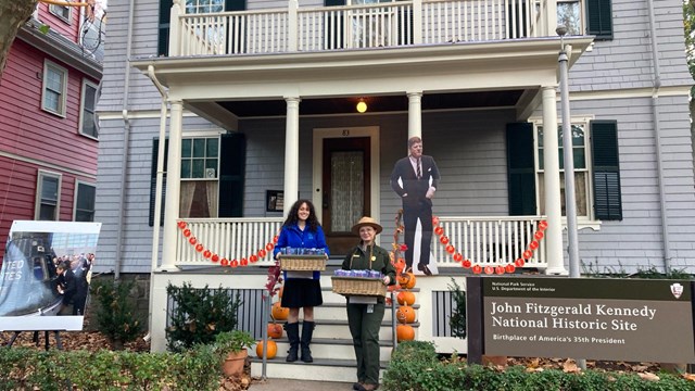 Photo of Park Ranger and SCA intern on the porch of the JFK birthplace for Halloween in 2023.