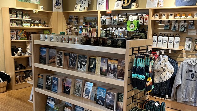 Photograph of the park store with book shelfs full of clothes, books and gifts. 