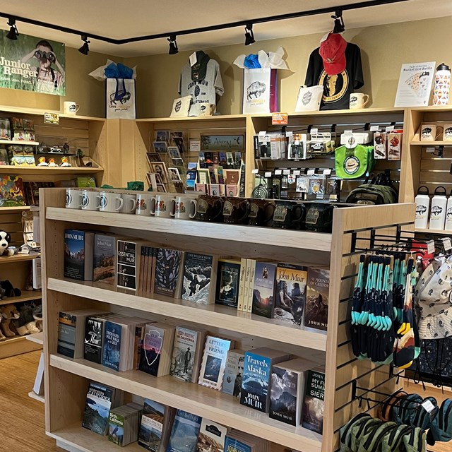 Photograph of the park store with book shelfs full of clothes, books and gifts. 