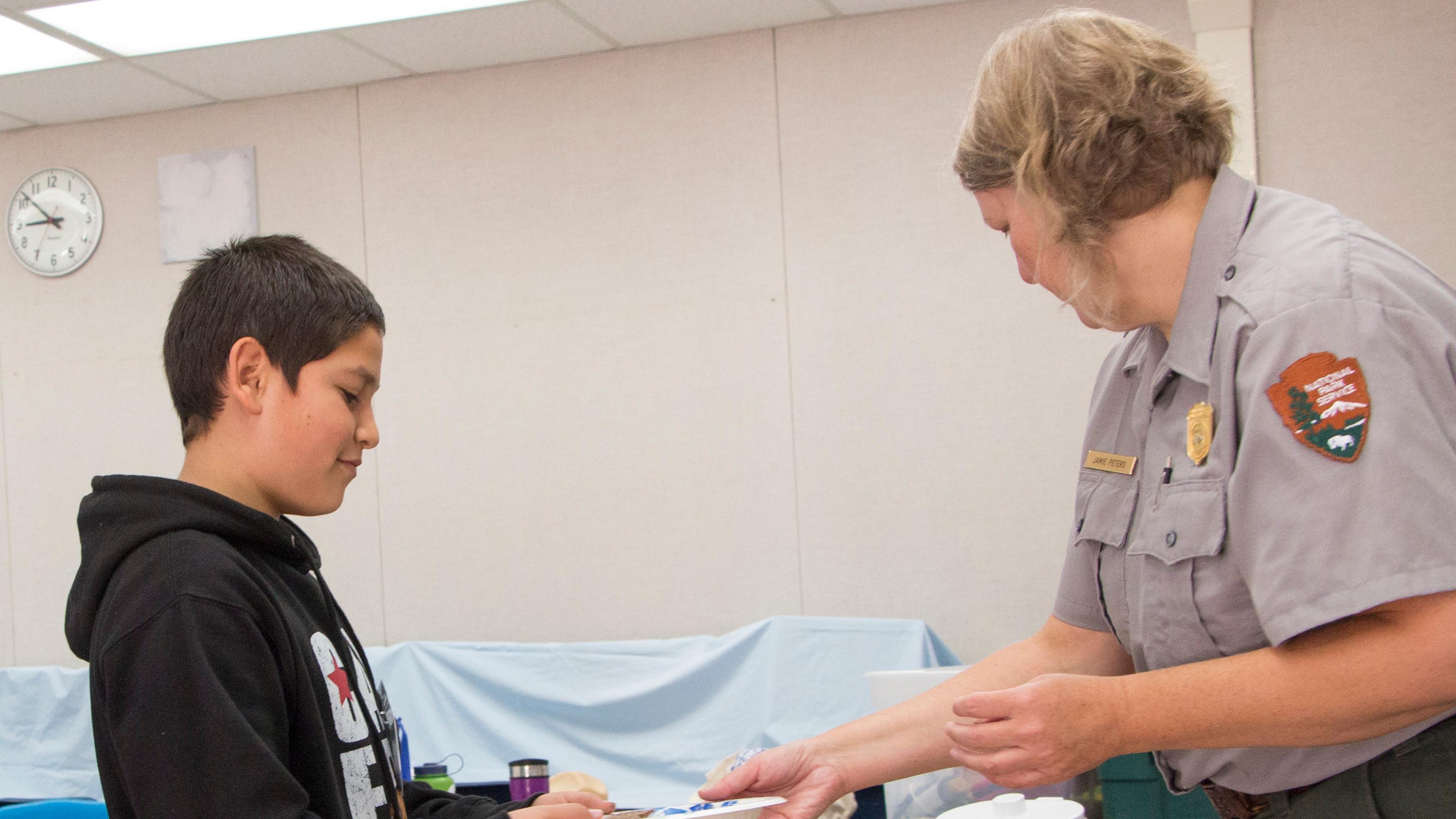 A ranger and student in a classroom setting. 