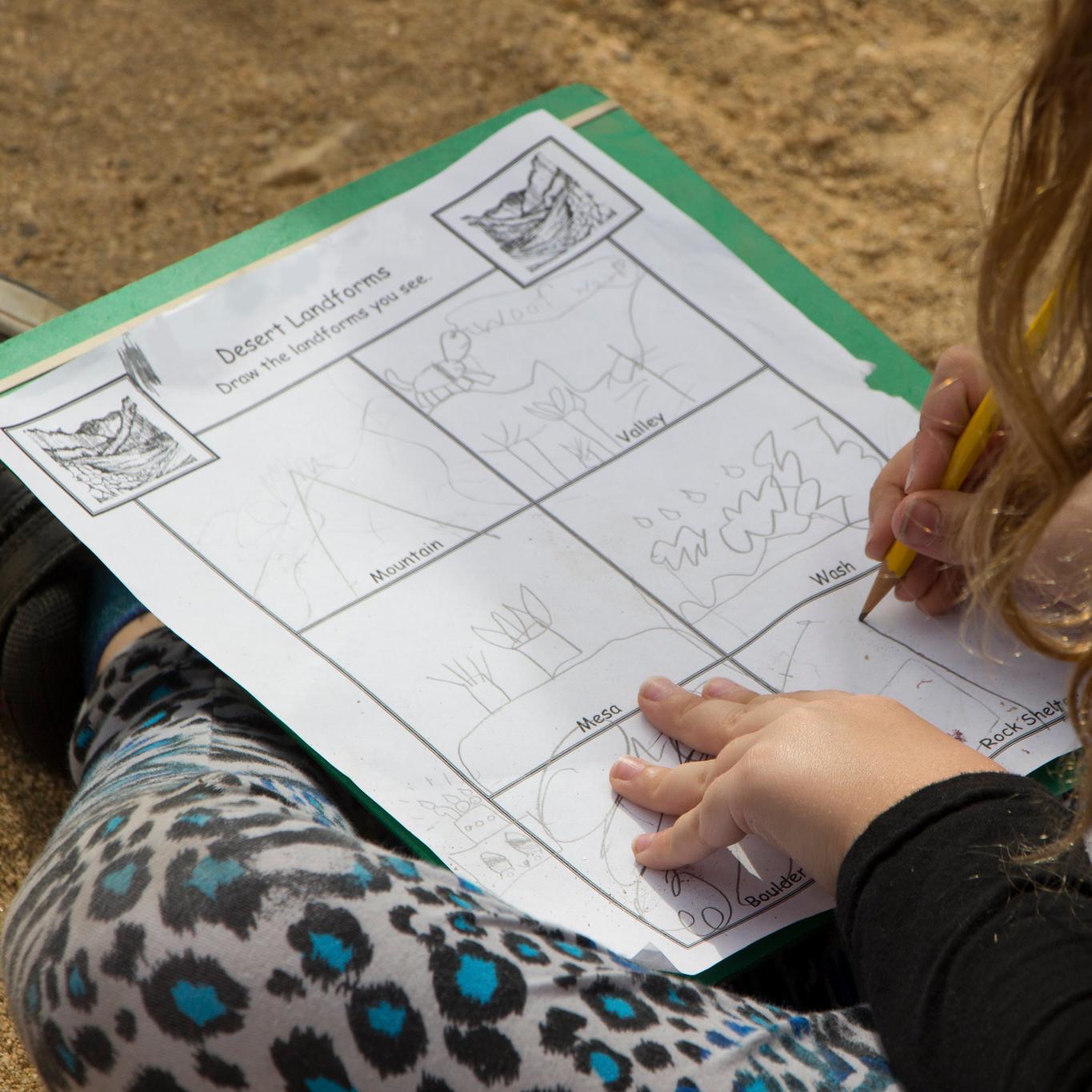 A young student filling out a sheet