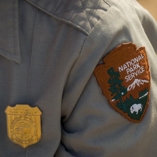 closeup of a park ranger's uniform showing official badge and patch