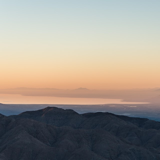 Color photo at first light looking out over the Salton Sea to the south of Joshua Tree.