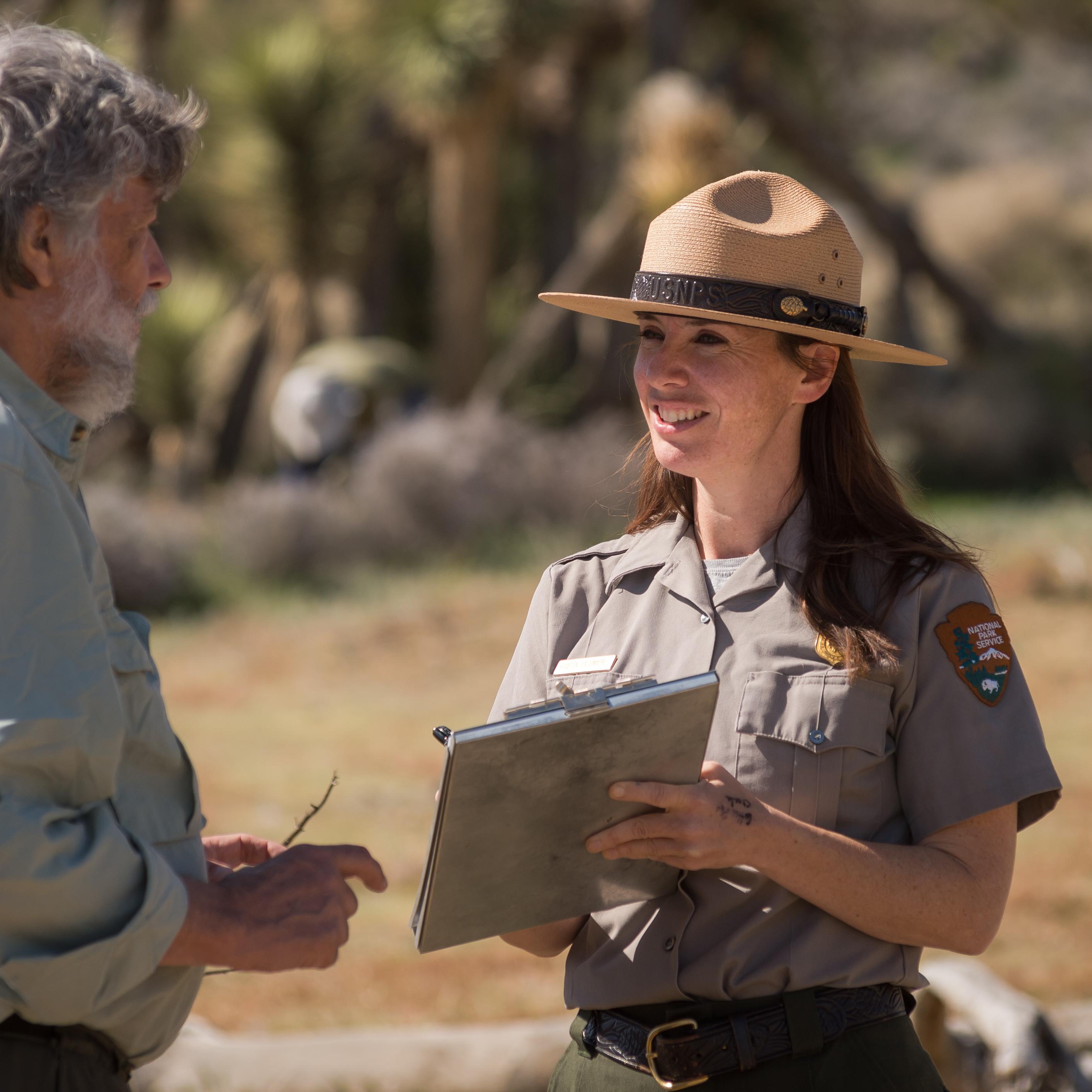 Park Ranger communicating with volunteer. 