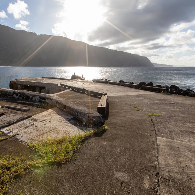 A cement pier and ocean. 