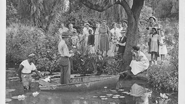 Old photo of a ranger giving a tour on a boat