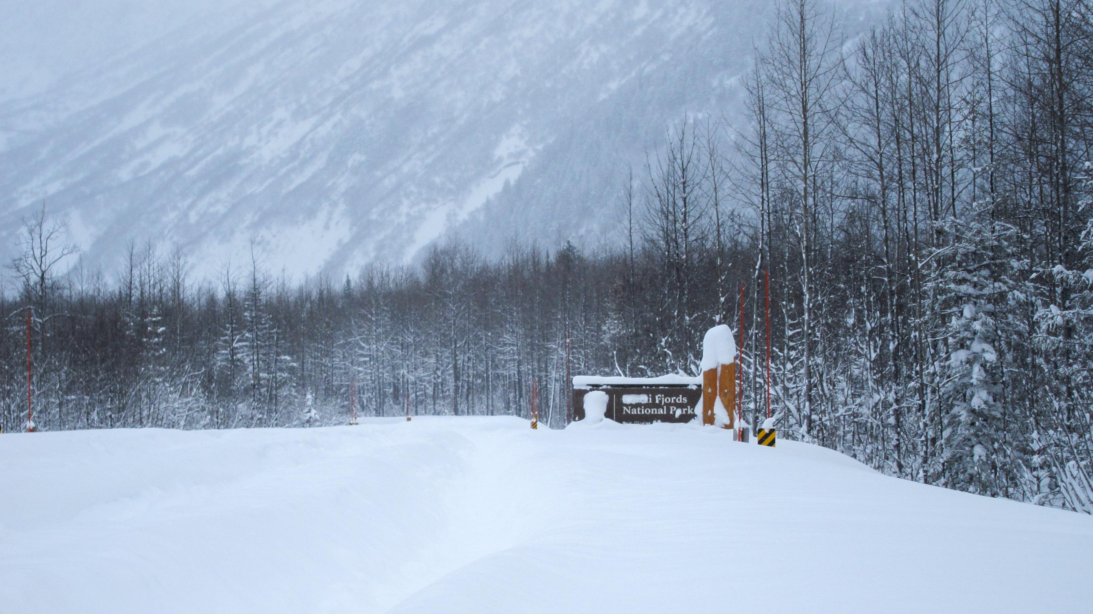 Kenai Fjords National Park sign and road under snow