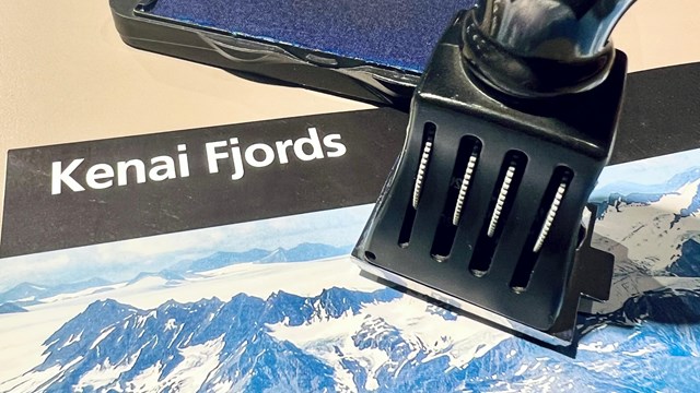 A stamp on top of a Kenai Fjords brochure