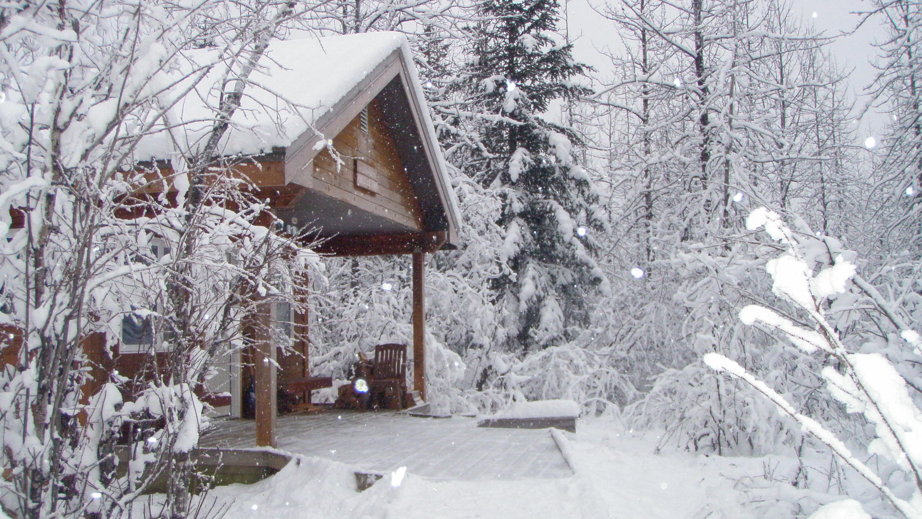 A cabin covered in snow