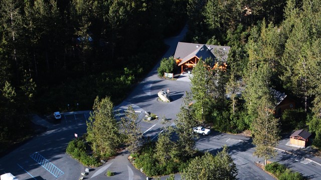 An aerial photo of a visitor center and parking lot
