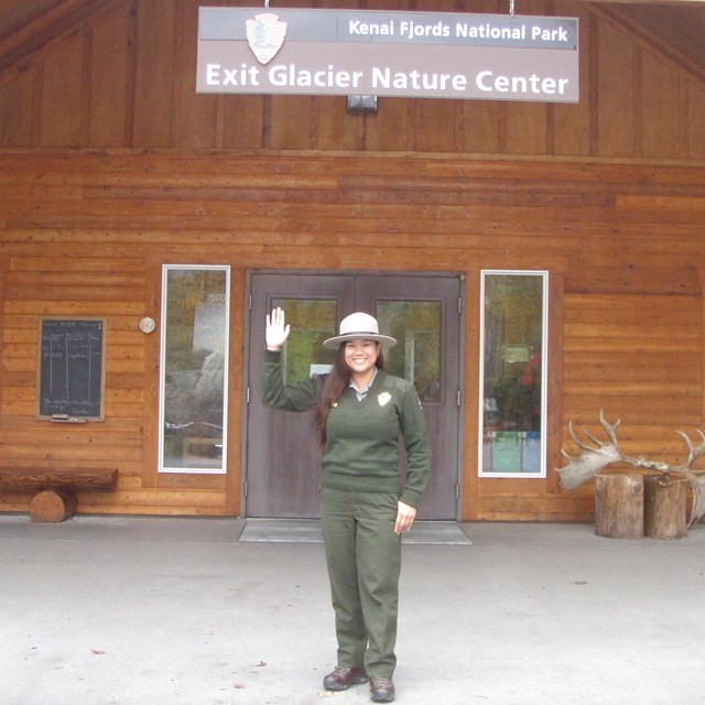 A park ranger waves in front of the Exit Glacier Nature Center. 