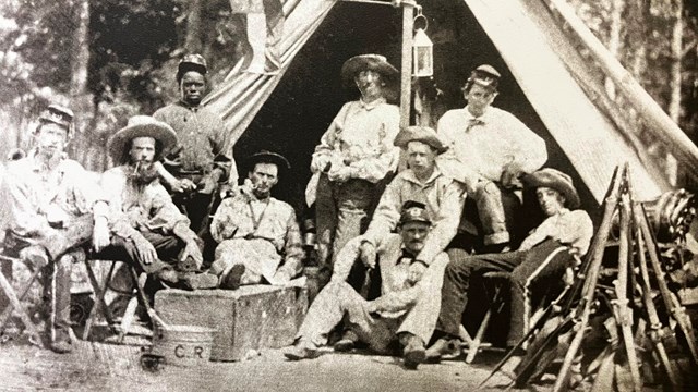 Black and white image of Civil War era soldiers resting at camp