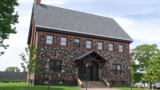 A two-story building constructed of brick and stone.