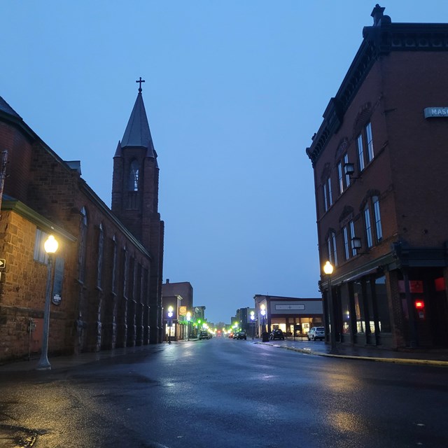 Image shows downtown calumet at dawn, links to an article on Calumet Unit Cultural Landscapes
