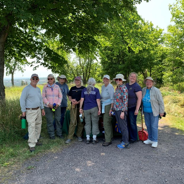 A group of park volunteers gather after a hard day's work for a group photo.