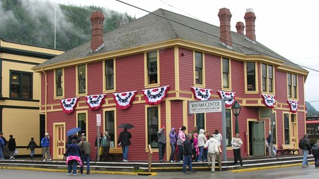 Red building with patriotic bunting located on a street corner