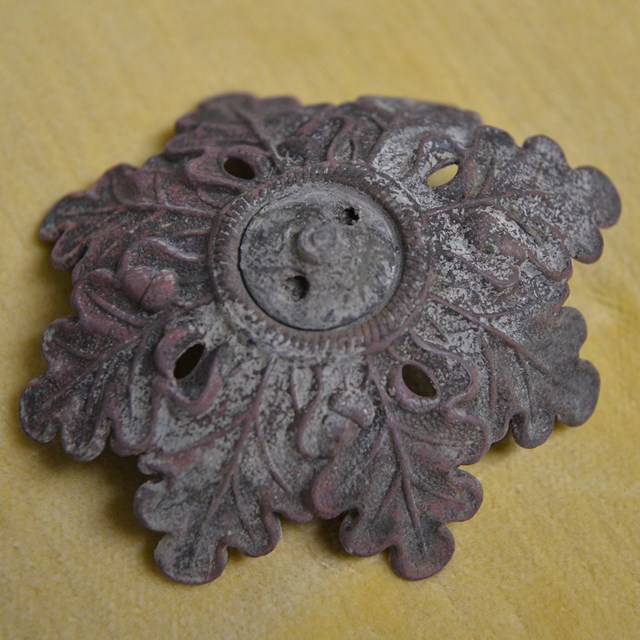 Metal object decorated with oak leaves