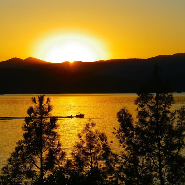 Sunset over boat on Whiskeytown Lake