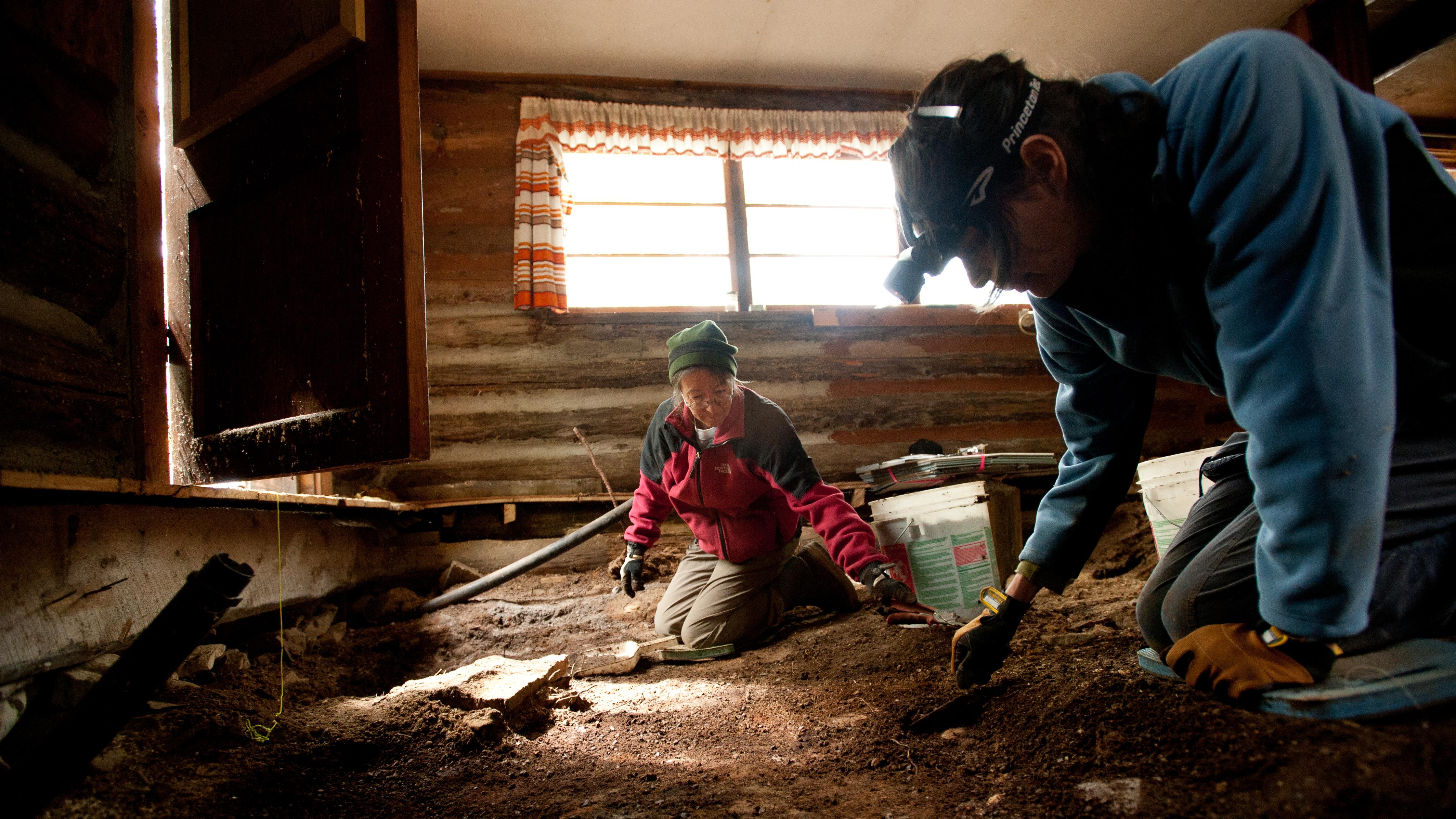 two people excavating an archeological site