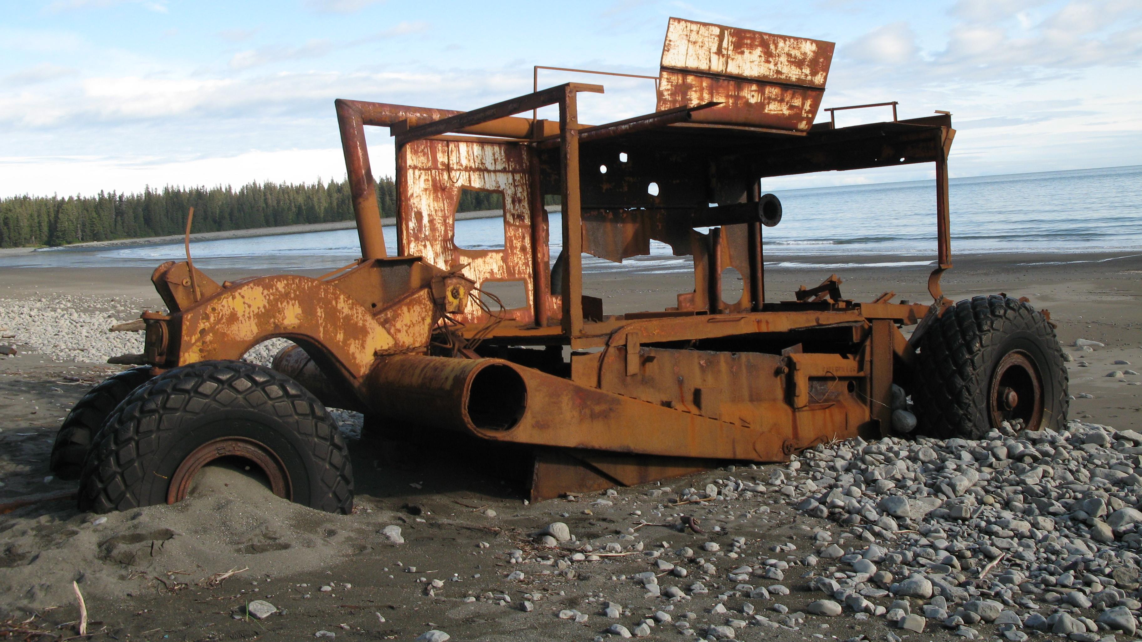 A semi-buried clam dredge in the sand