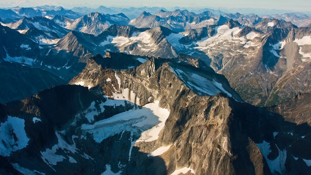 An aerial view of jagged rust-colored mountains